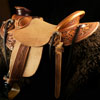 Wade tree, 15 inch seat, Gullet - 7 and 1/2 inch by 6 and 1/4 inch by 4 inch, Horn 4&1/2 inch round, 90 degree bars, 7/8ths full in-skirt riggin, Cheyenne Roll, Buckaroo outside leathers, half-breed Wade Saddle built and tooled with original floral and border design by Keith Valley.